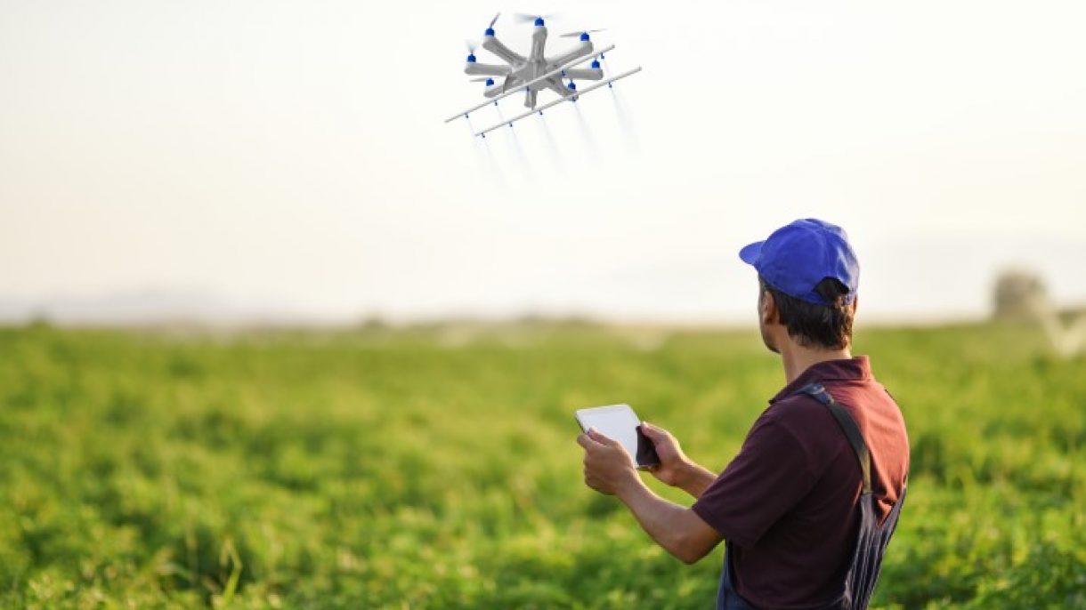 Farmer spraying his crops using a drone