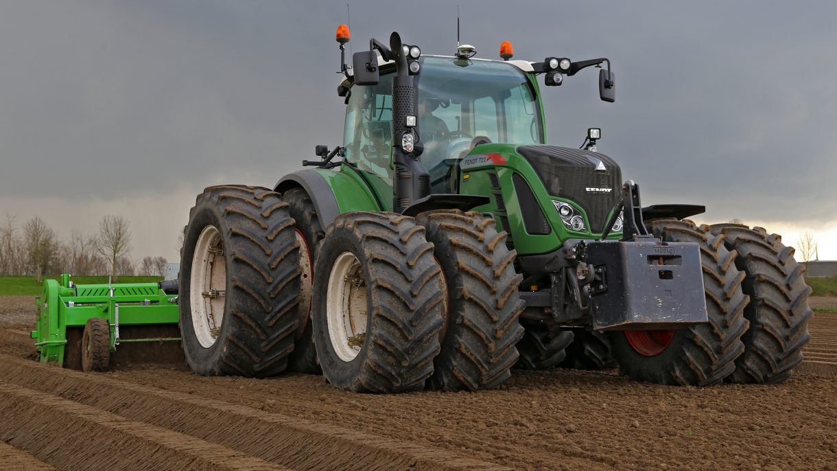 Trekker met dubbele banden op het land